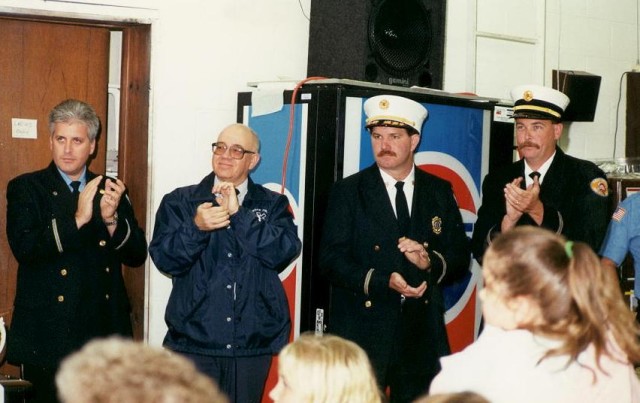 Applauding a speaker at the 1998 Housing at Station 12